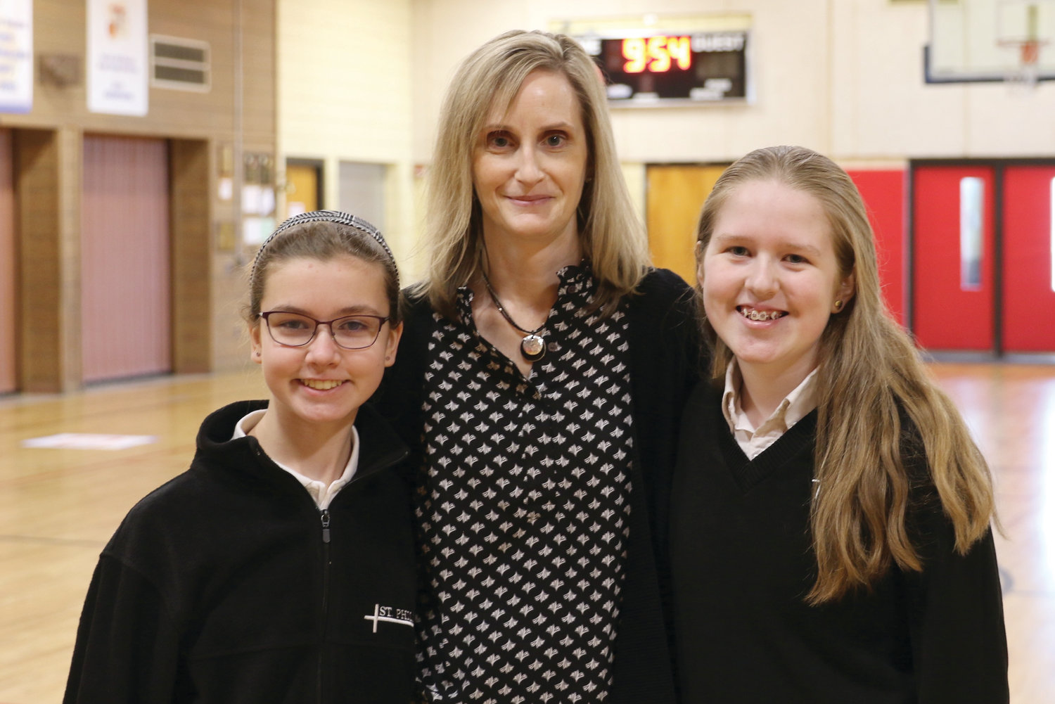 Pictured from left:  Laurel Christensen, Saint Philip School Principal Cynthia Senenko, and Anna Vredenburg